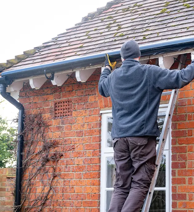 Man working on Eavestrough